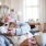 An active adult sitting on a couch with a dog at our 55 and over senior apartments in Noblesville, IN.