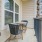 Model balcony at one of our senior apartments for rent in Noblesville, IN, featuring two seats and a small table.