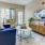 Model living room at our senior living community in Noblesville, Indiana, featuring couches and wood grain floor paneling.