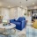 Model living room at our senior living community in Noblesville, Indiana, featuring couches and wood grain floor paneling.