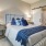 a bedroom with a bed and lamps